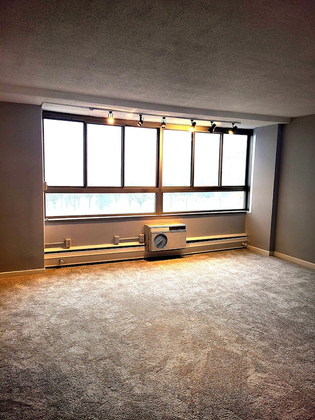 8900 E Jefferson Ave # 908 # 909, Detroit, MI 48214 - empty room with a textured ceiling, carpet, baseboards, and a baseboard radiator