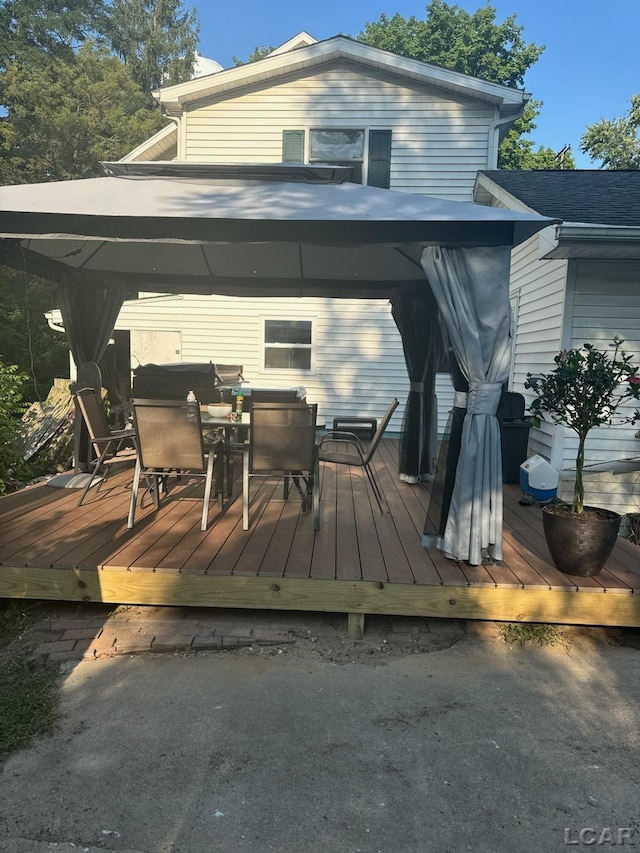 wooden deck featuring a gazebo and area for grilling