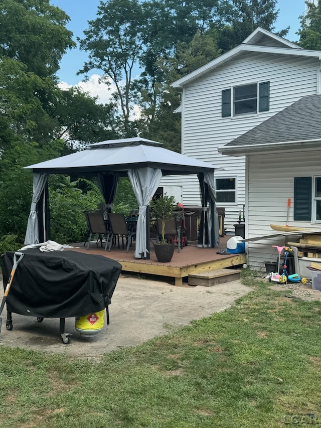 back of property featuring a gazebo, a yard, and a wooden deck