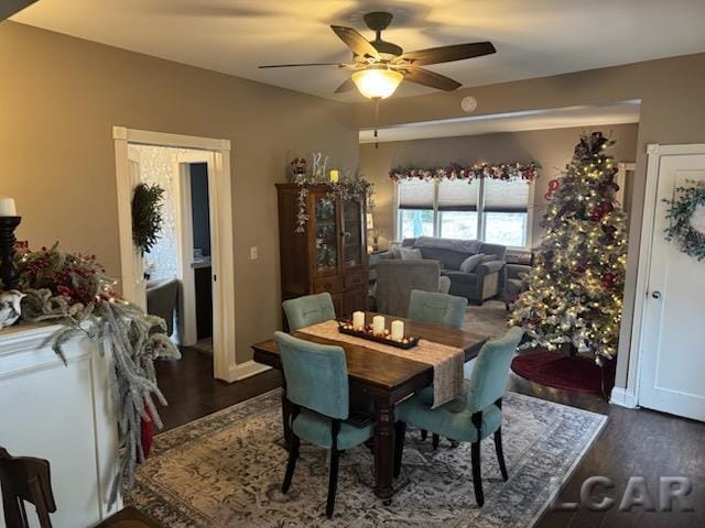 dining space featuring ceiling fan and dark wood-type flooring