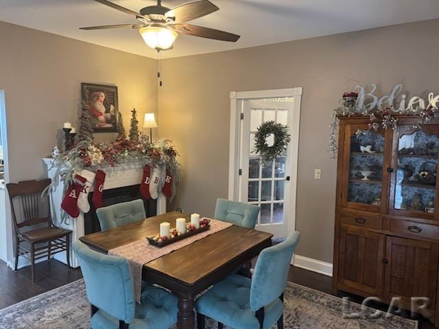 dining room with ceiling fan and dark hardwood / wood-style flooring