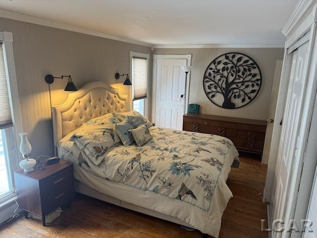 bedroom with ornamental molding and hardwood / wood-style flooring