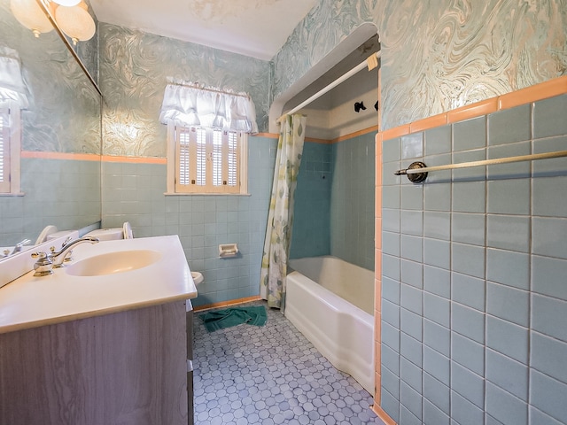 bathroom featuring shower / bath combo, vanity, tile patterned floors, and tile walls