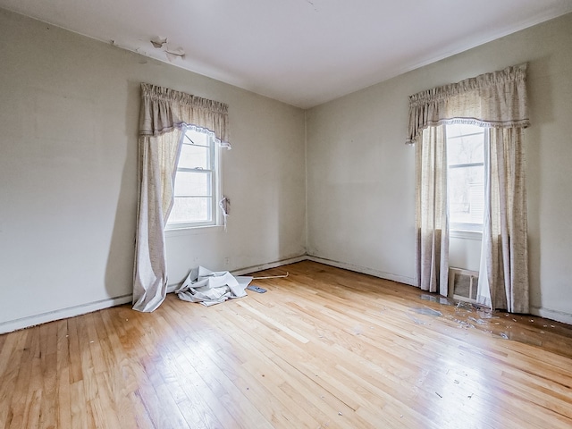 unfurnished room with light wood-type flooring