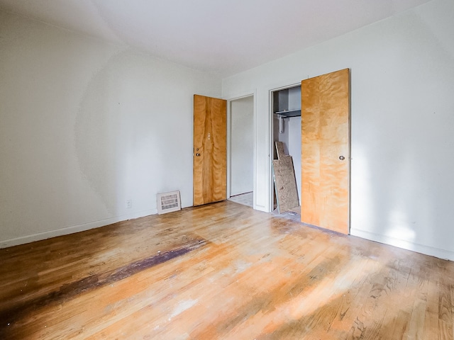 unfurnished bedroom with hardwood / wood-style floors