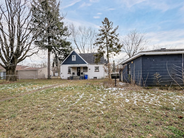 back of house with a lawn