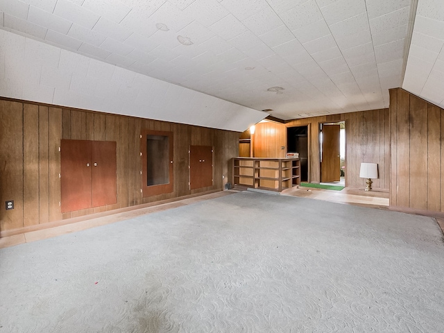 interior space featuring wood walls and lofted ceiling