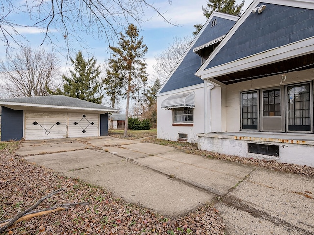 view of side of property with a garage and an outdoor structure