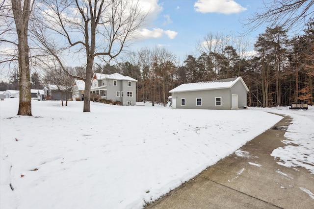 snowy yard with an outbuilding