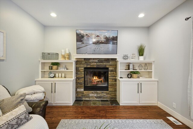 living room with a fireplace and dark hardwood / wood-style floors