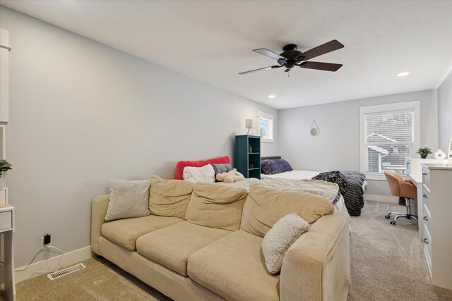 bedroom featuring multiple windows, light carpet, and ceiling fan