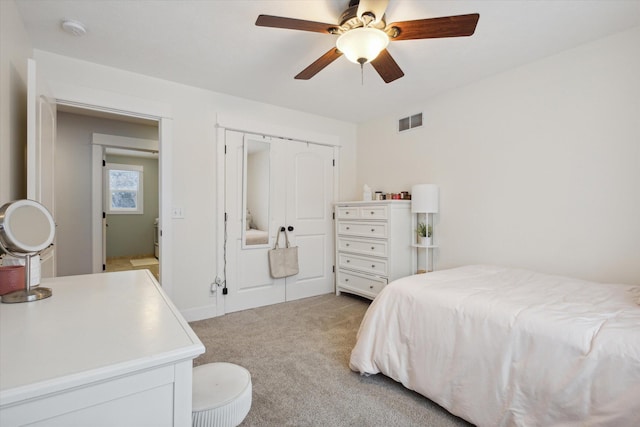 bedroom featuring ceiling fan, light carpet, and a closet