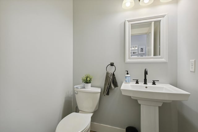 bathroom featuring toilet and sink