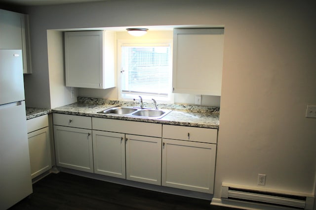 kitchen featuring white cabinets, white refrigerator, sink, dark hardwood / wood-style floors, and a baseboard radiator