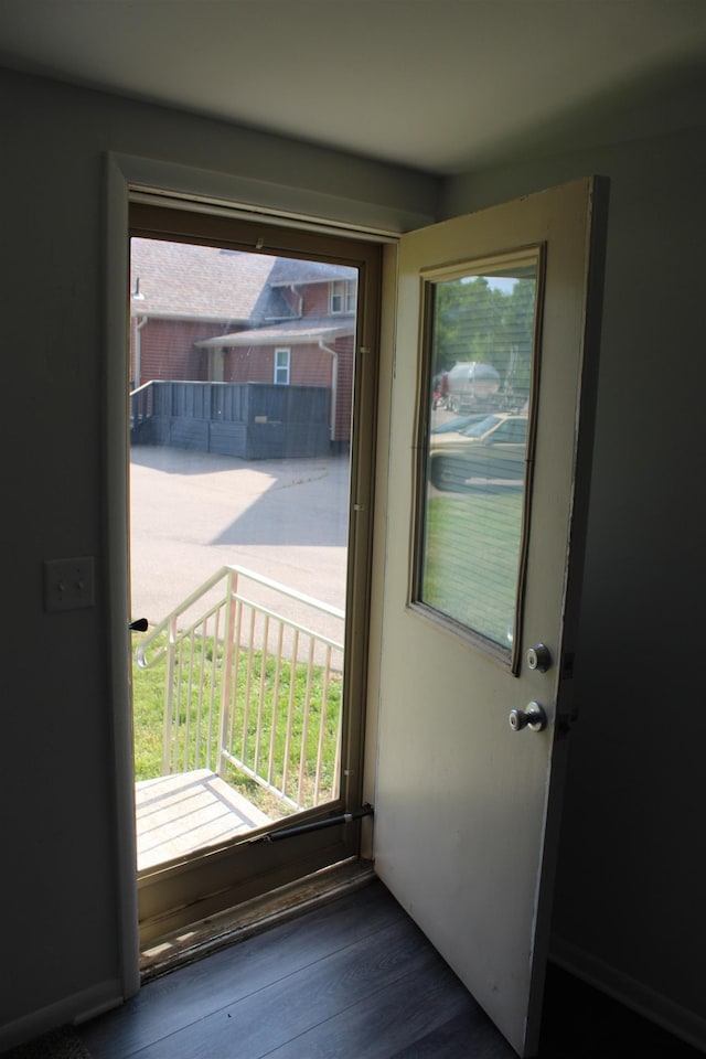 doorway with dark hardwood / wood-style floors