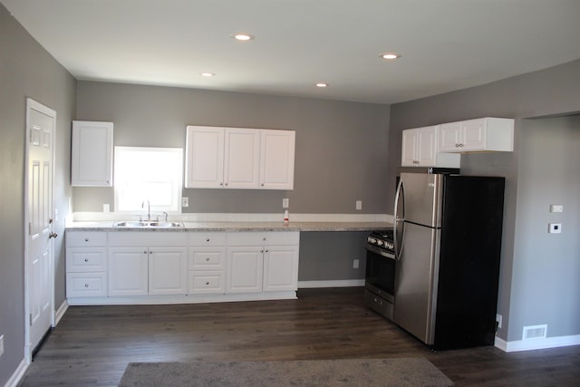 kitchen featuring dark hardwood / wood-style flooring, sink, white cabinets, and stainless steel appliances