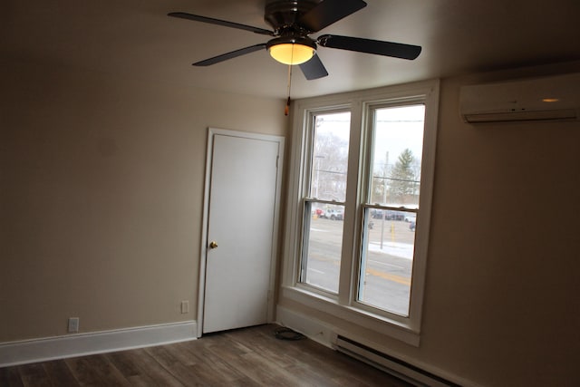 spare room with a baseboard radiator, an AC wall unit, ceiling fan, and dark wood-type flooring