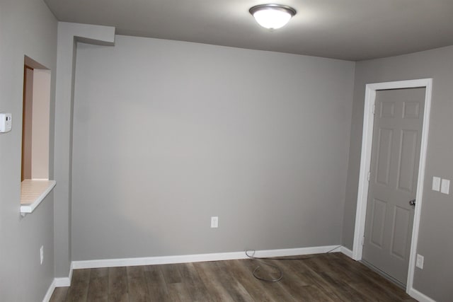 unfurnished room featuring dark hardwood / wood-style floors