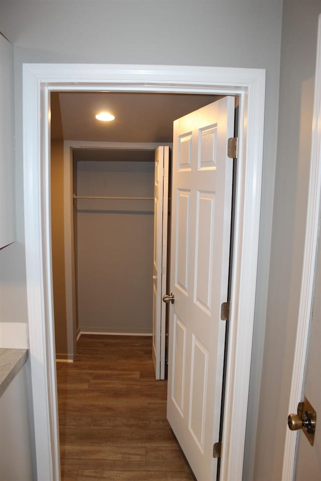 corridor with dark wood-type flooring