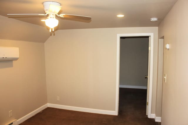 carpeted spare room featuring ceiling fan, a wall unit AC, and a baseboard radiator