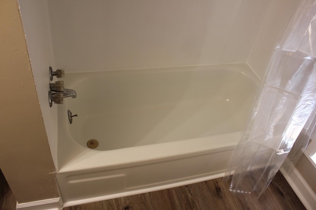 bathroom featuring hardwood / wood-style flooring and shower / bath combo