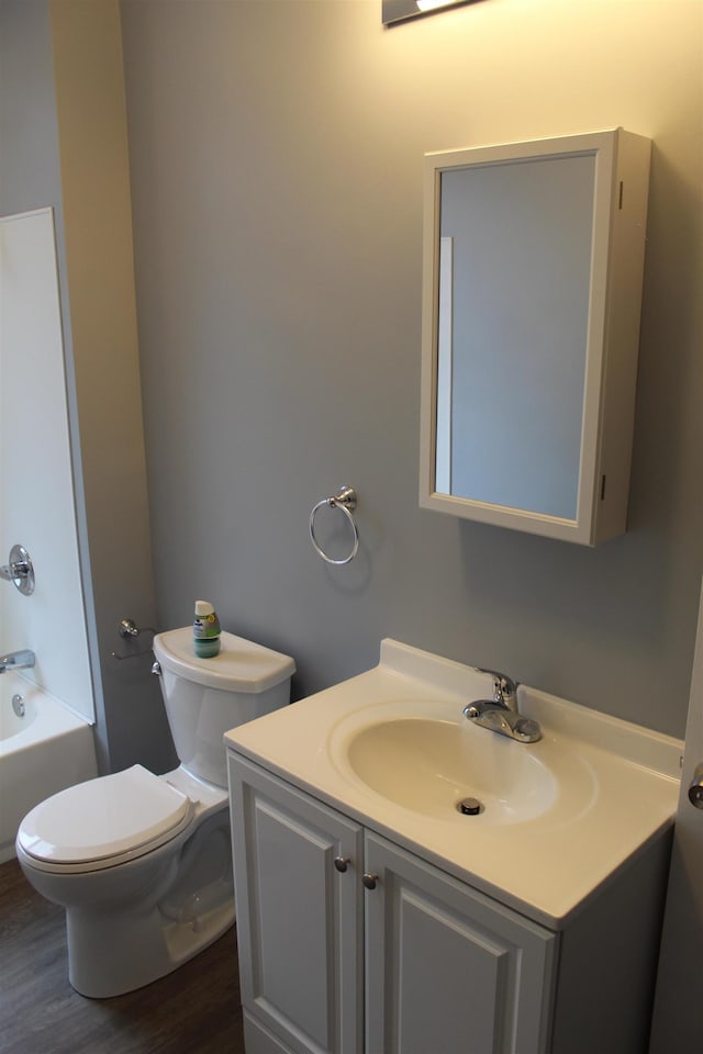 bathroom featuring vanity, hardwood / wood-style flooring, and toilet