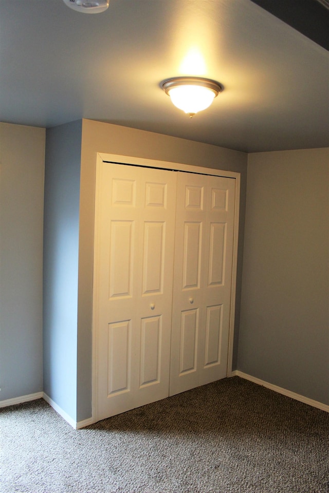 unfurnished bedroom featuring carpet floors and a closet