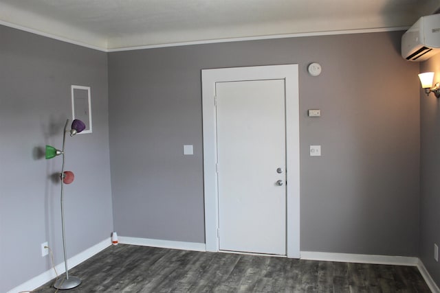 entrance foyer featuring dark wood-type flooring and a wall mounted air conditioner