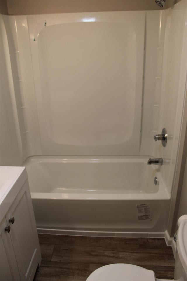 full bathroom featuring wood-type flooring, vanity, toilet, and tub / shower combination