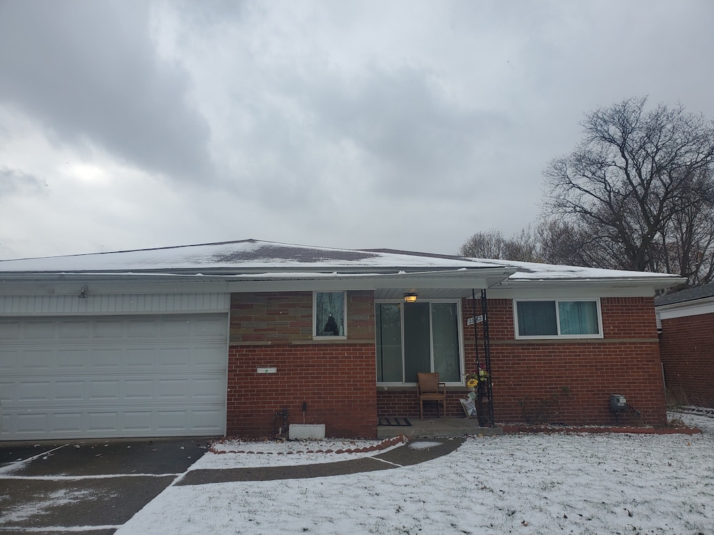 28623 Panama St, Warren, MI 48092 - view of front of house with brick siding, asphalt driveway, and a garage