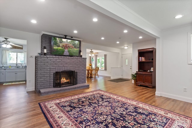 living room featuring crown molding, hardwood / wood-style floors, and a healthy amount of sunlight