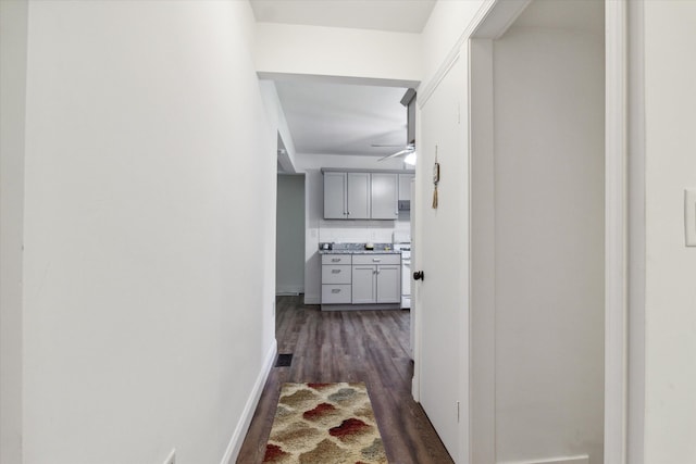 corridor featuring dark wood-type flooring