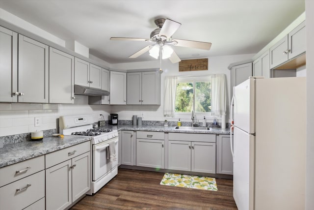 kitchen featuring dark hardwood / wood-style flooring, ceiling fan, sink, and white appliances