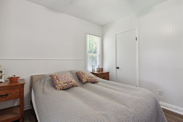 bedroom with dark hardwood / wood-style floors