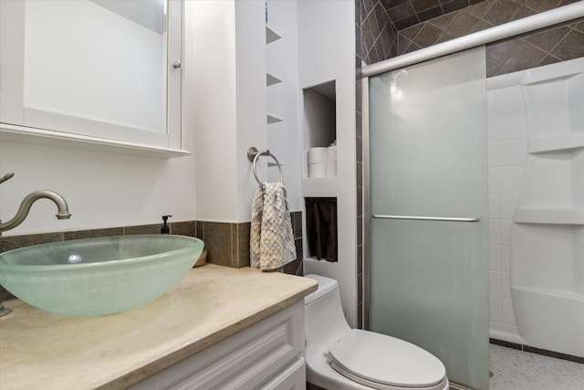 bathroom featuring vanity, toilet, and walk in shower