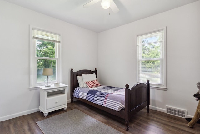 bedroom featuring multiple windows, ceiling fan, and dark wood-type flooring