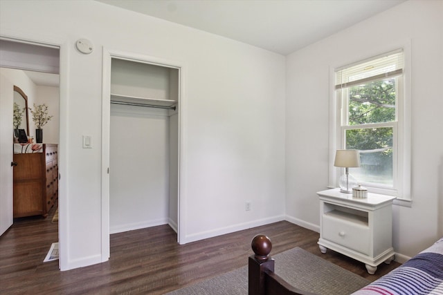 bedroom featuring dark hardwood / wood-style floors and multiple windows