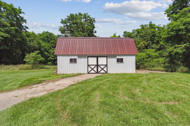 view of outbuilding with a lawn