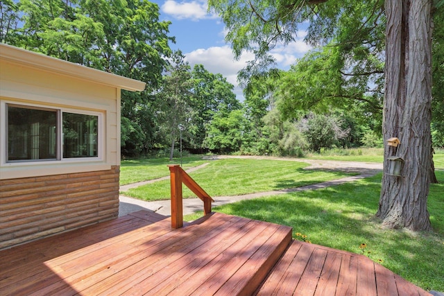 wooden terrace with a lawn