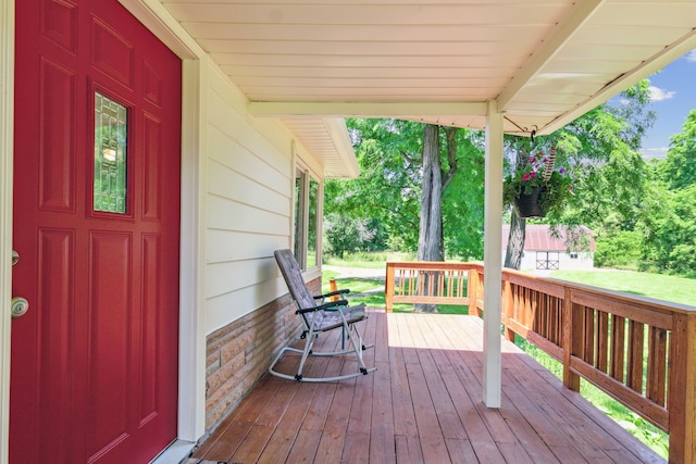 wooden terrace featuring covered porch