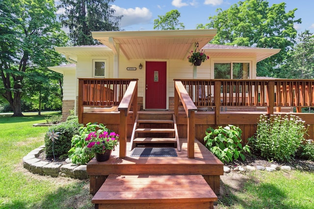 exterior space featuring a wooden deck and a yard