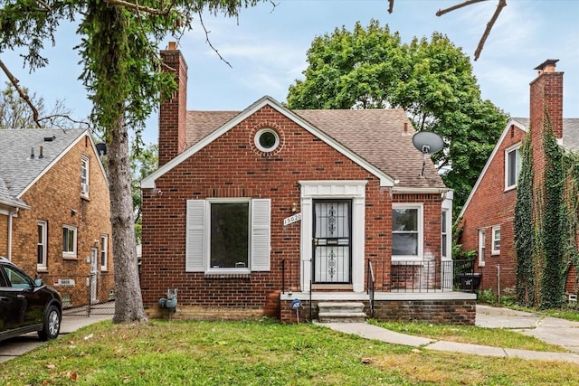 bungalow-style home with a front lawn