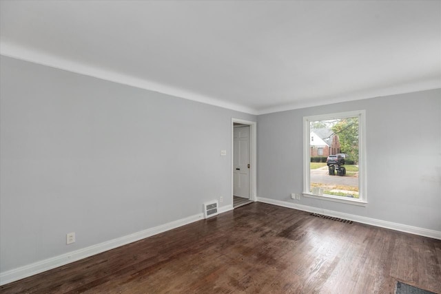 spare room with dark wood-type flooring