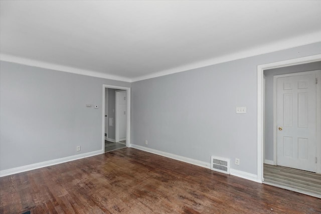 unfurnished room featuring dark wood-type flooring