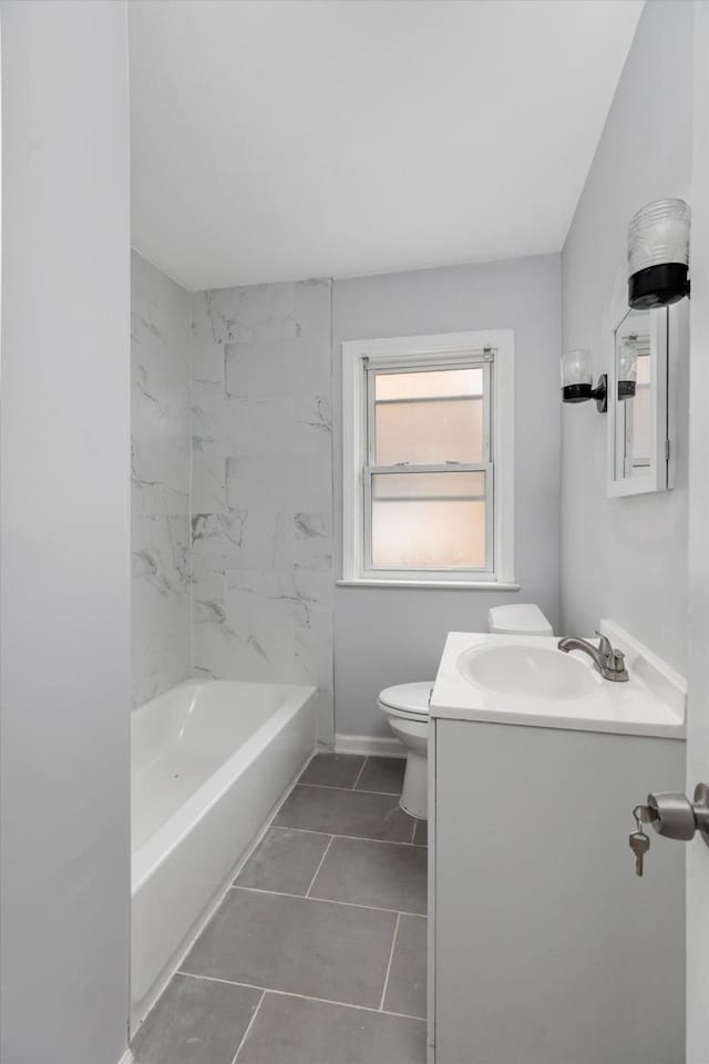 full bathroom featuring tile patterned floors, vanity, toilet, and tiled shower / bath