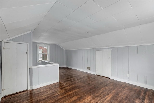 additional living space with lofted ceiling and dark wood-type flooring