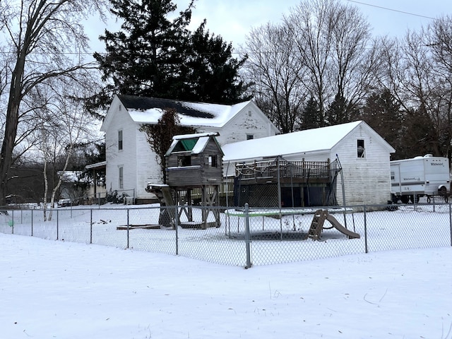 snow covered property with a deck