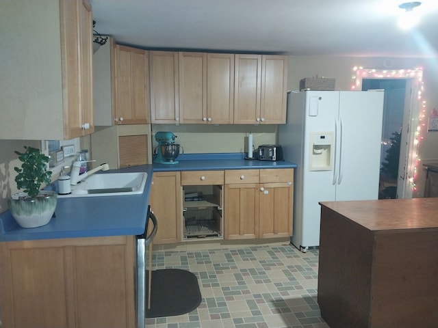 kitchen with white fridge with ice dispenser and sink