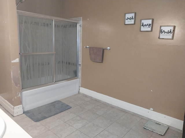 bathroom featuring tile patterned floors and combined bath / shower with glass door