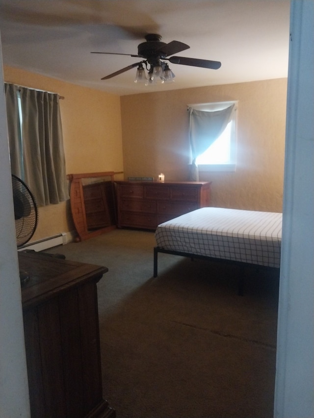 carpeted bedroom featuring ceiling fan and a baseboard heating unit